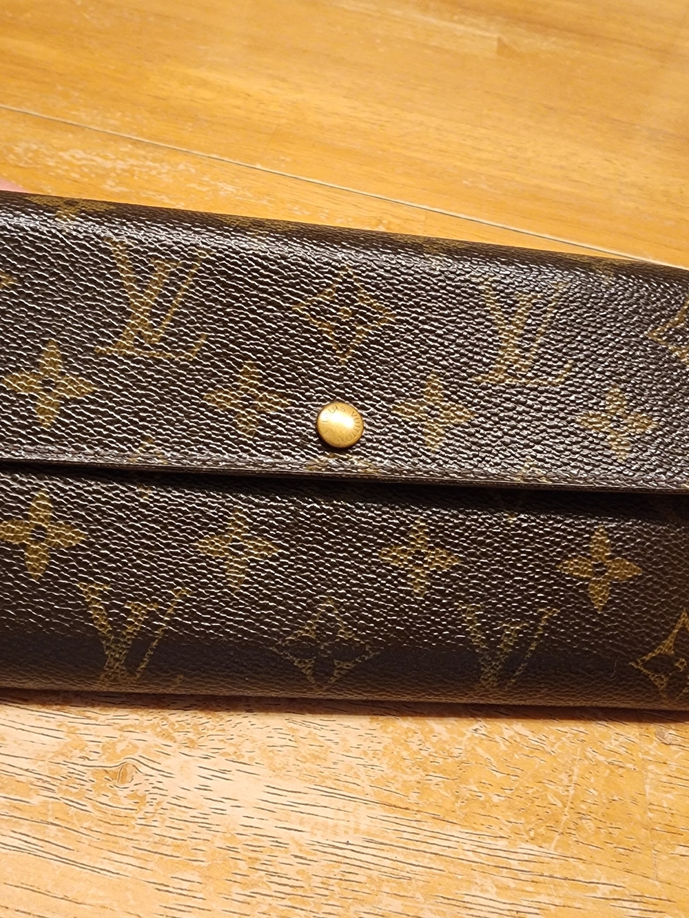 Louis Vuitton Sarah Wallet in classic Monogram canvas featuring  gold-color snap
